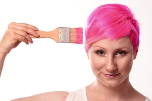 Woman painting her hair pink to illustrate a concept in brain training