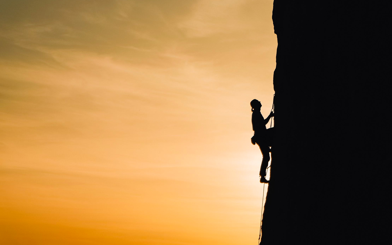 a man climbing a mountain