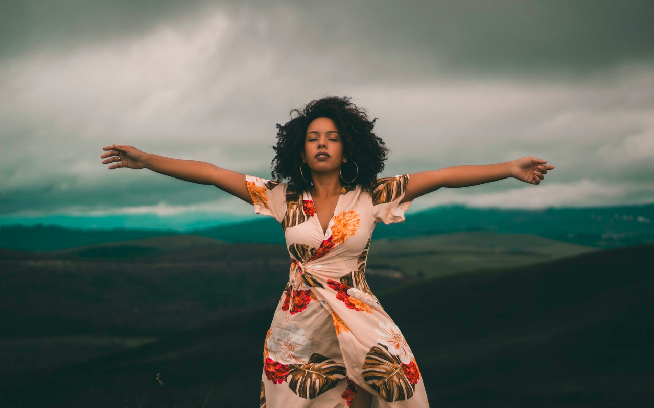 a woman holding her arms open wide