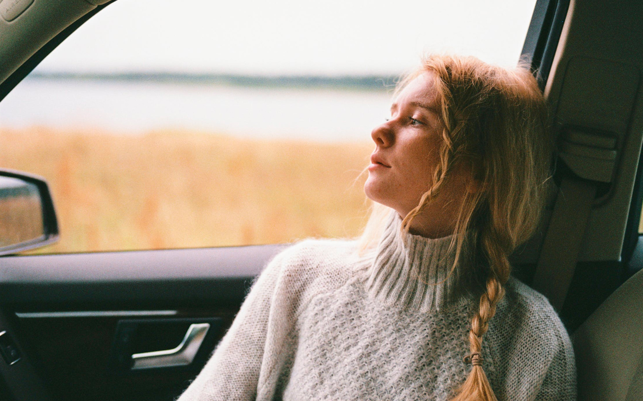 a women is thinking in a car