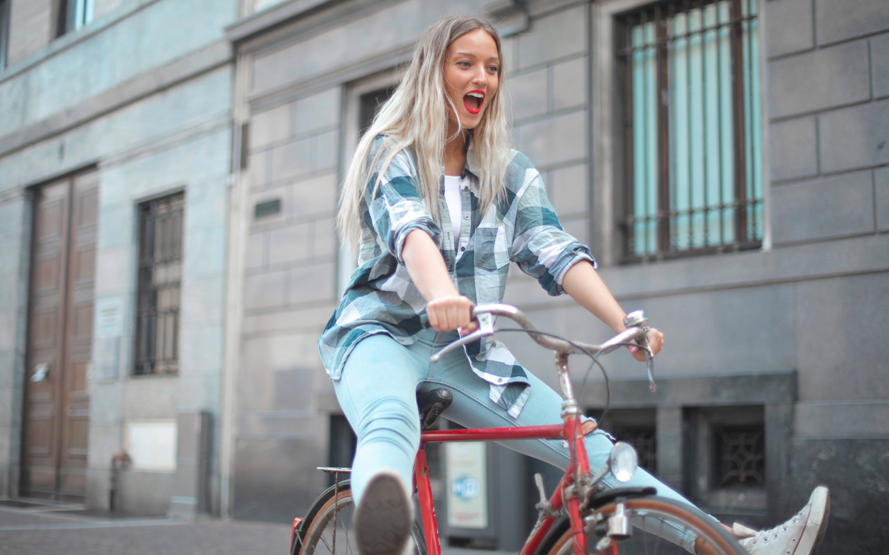 a-woman-is-riding-a-red-bike a woman is riding a red bike