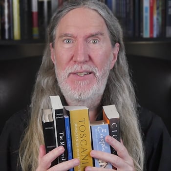 Slow reader feature image of Anthony Metivier holding books