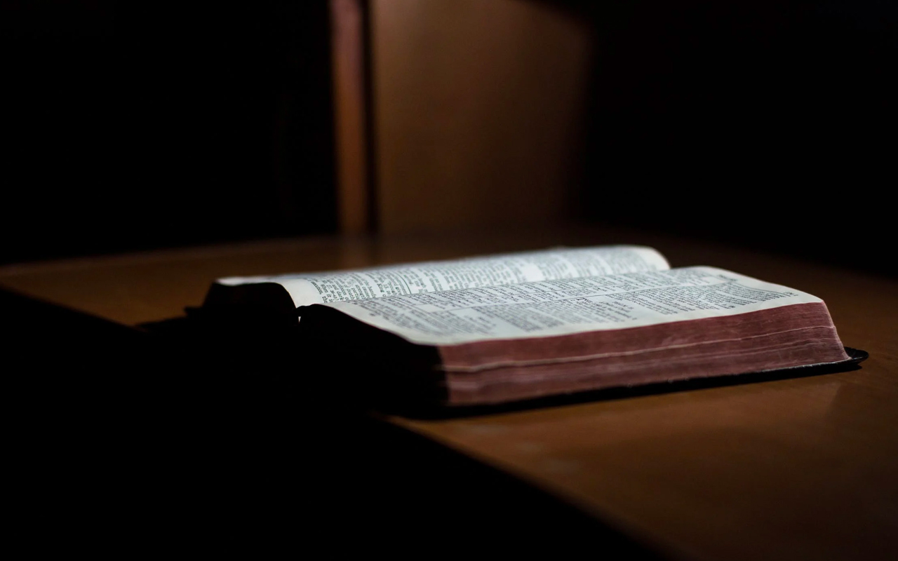 an opened book in dim light
