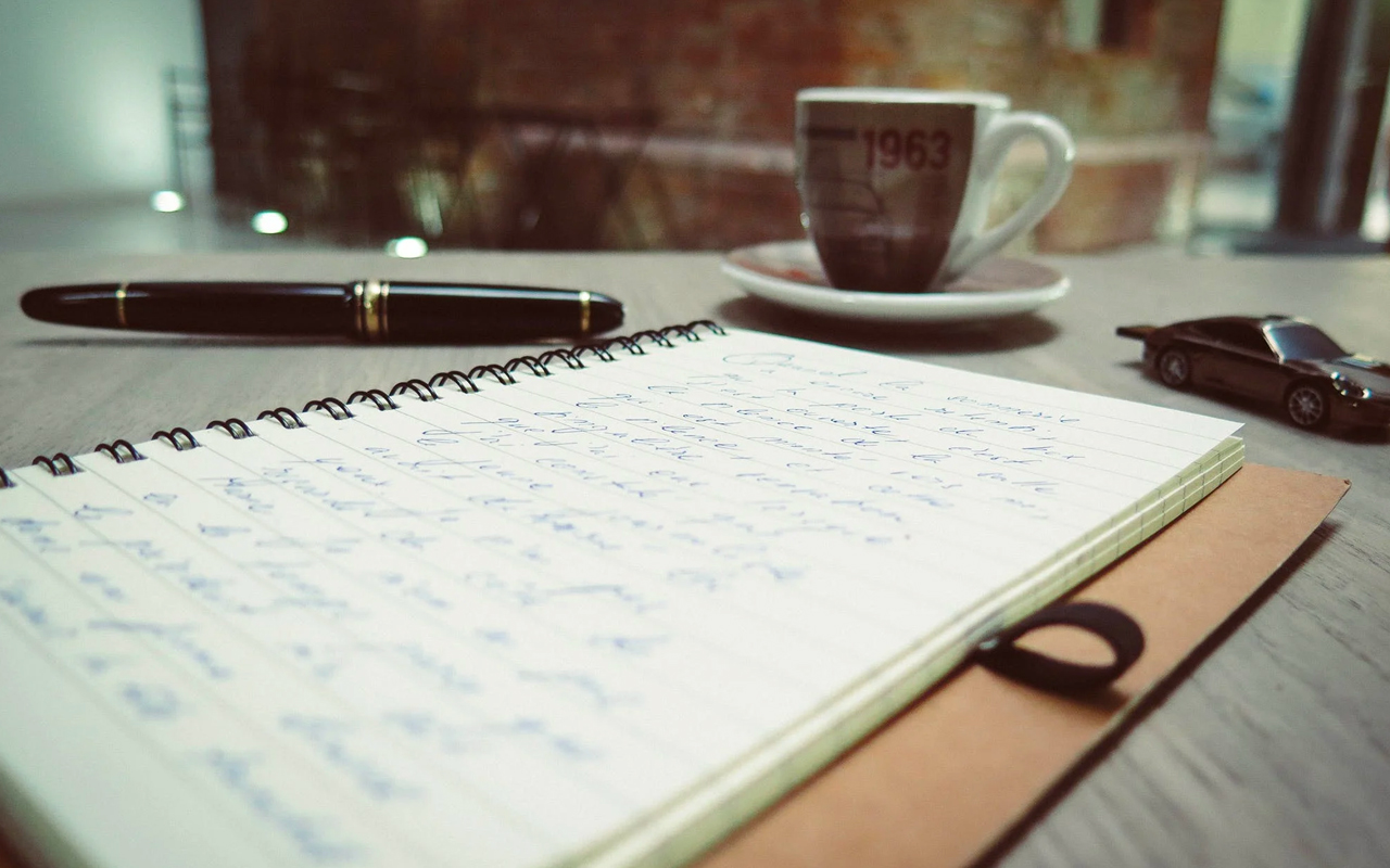 black pen and notes on a desk