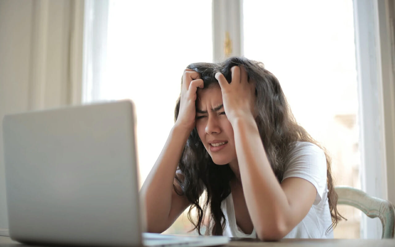 a confused girl is scratching her head