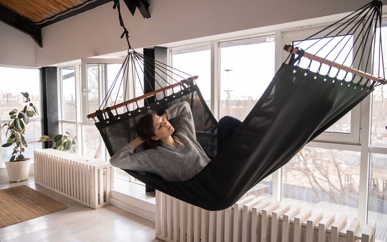 a woman is relaxing in a black bed