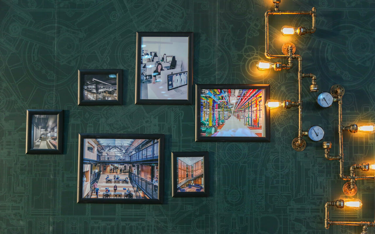 pictures on a green wall with lights