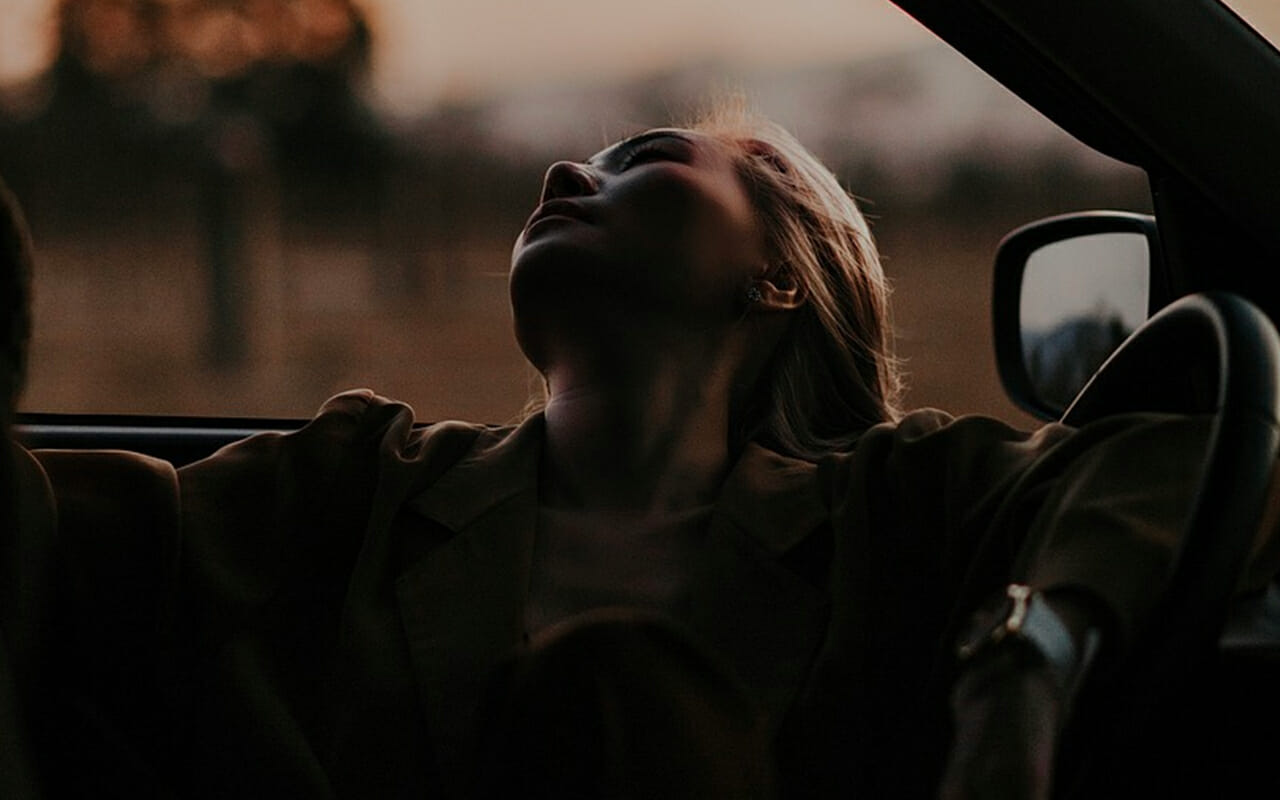 Woman resting in car to illustrate how memory bias is usually unconscious