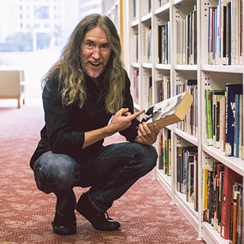 Anthony Metivier pointing to a book to illustrate a concept about how to learn faster