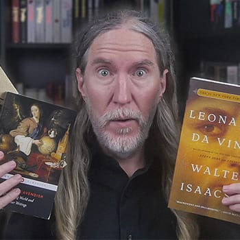 Anthony Metivier holding books about autodidacts
